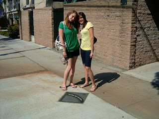 Girls pose at walk of fame outside studio of According to Jim