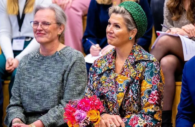 Queen Maxima wore a floral brocade long coat by Oscar de la Renta. The Queen wore a green v-neck midi dress by Natan