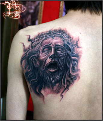 a crying man portrait  tattoo on the back