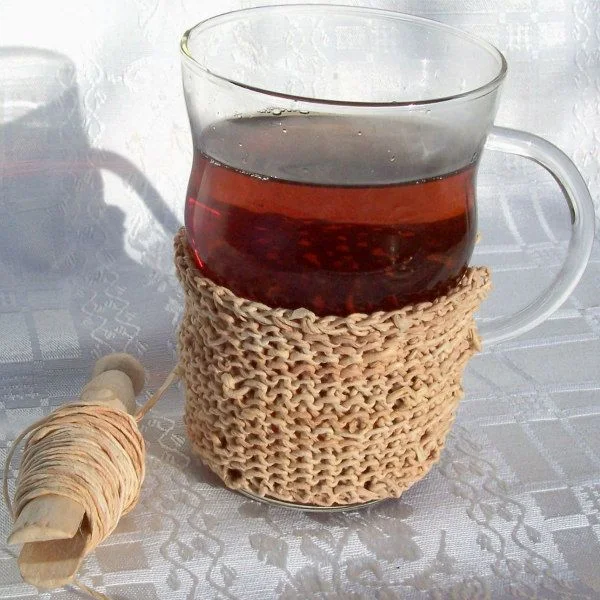 cup of tea with a crocheted cozy made of tea-dyed paper twine