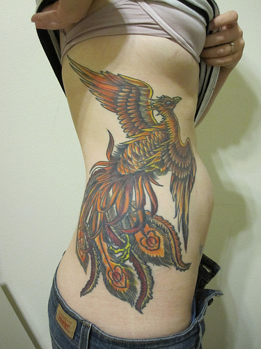Phoenix tattoo on woman body a part waist with colour full constitute best