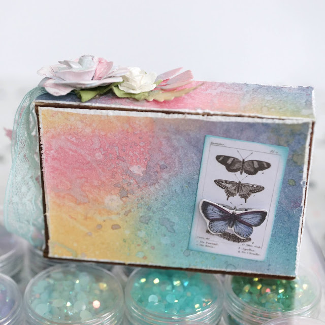 Embrace the Journey mixed media mini vignette with inked background: Tim Holtz mini vignette box, distress oxide inks, blending brush, distress glaze, funky floral and funky nature die cuts, metal butterfly adornment, small talk sticker; Pima With Love paper flowers; Scrapbook.com mint tape, solar white cardstock