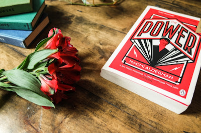 The Power by Naomi Alderman, Book Review on Typewriter Teeth with flowers and a stack of books