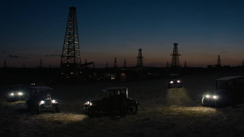 Oil derrick field at night