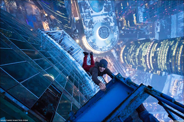 Man hanging from a Russian skyscraper
