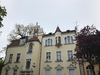 a cute cream building with turret roof against a blue sky