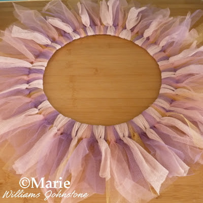 Tulle strips of netting tied around a wreath base