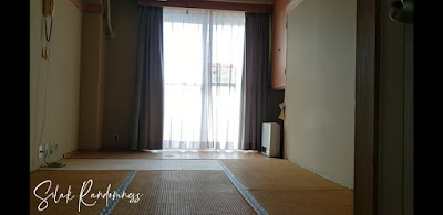 Japanese style bedroom with a large window