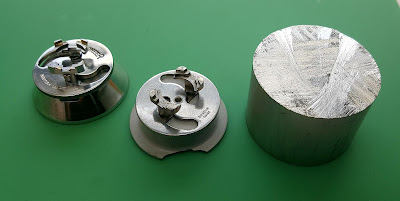 The Pioneer movement has an alloy base, but the Swiss Bradux holder has a plastic base