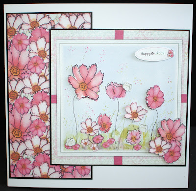 Photo o a hand nade card featuring pink cosmo flowers in several  layers.
