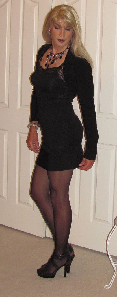 Pretty crossdresser in black pantyhose and heels