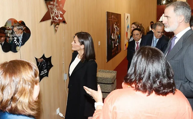 Queen Letizia wore a new white blouse by Adolfo Dominguez, and a black wool and cashmere blend coat by Carolina Herrera