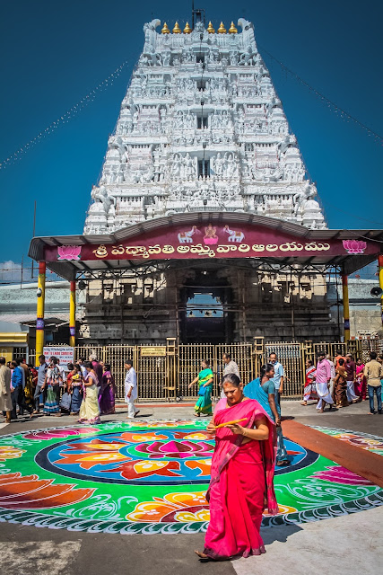 Entrance of a temple with a beautiful Rangoli in the front