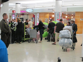 Cuban-Americans checking in huge poly-wrapped baggage at MIA