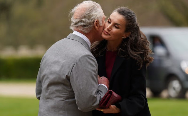 Queen Letizia wore a black wool and cashmere blend coat, and a new red midi dress by Carolina Herrera. The Prince of Wales