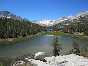 alpine lake surrounded by snow-capped mountain