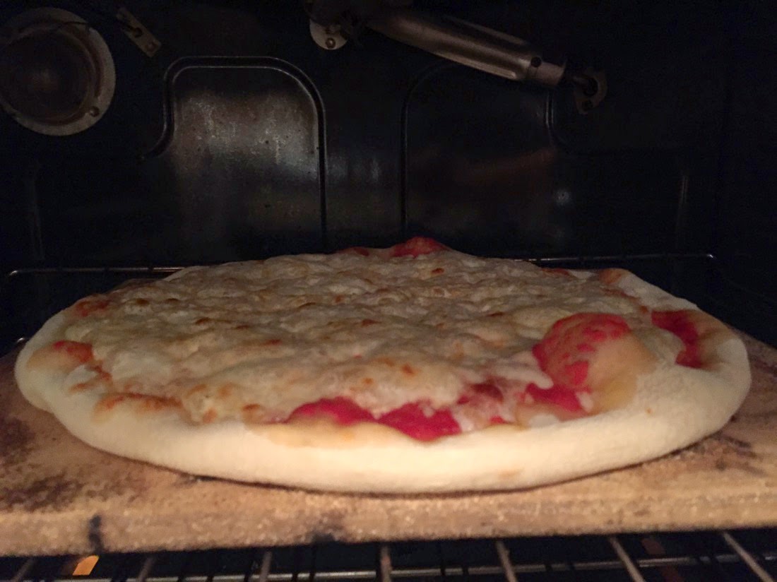 Image of pizza in the oven while being baked