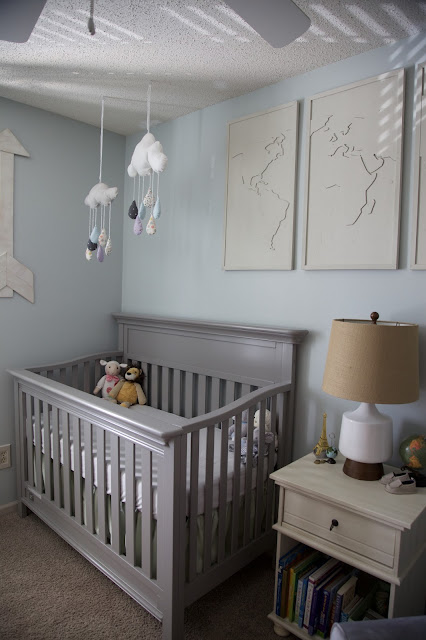 A travel and adventure-inspired gender neutral nursery with pops of burlap, pale gray, white, blue, and green.