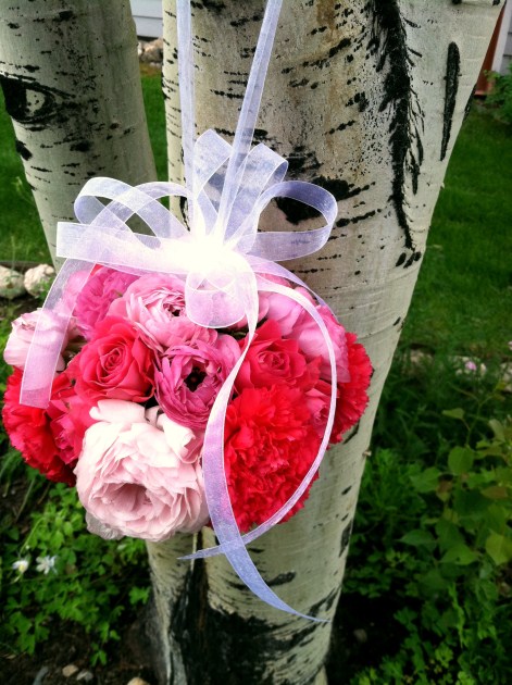 A pink pomander hangs on an Aspen tree just outside St Mary's Catholic 