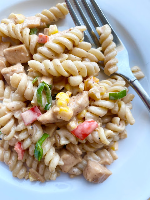 BBQ Chicken Pasta Salad on a white plate with fork.