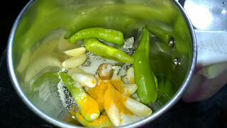 Grind green chiles, Garlic cloves, salt and turmeric