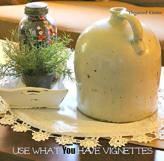Photo of a simple tabletop vignette with a button jar.