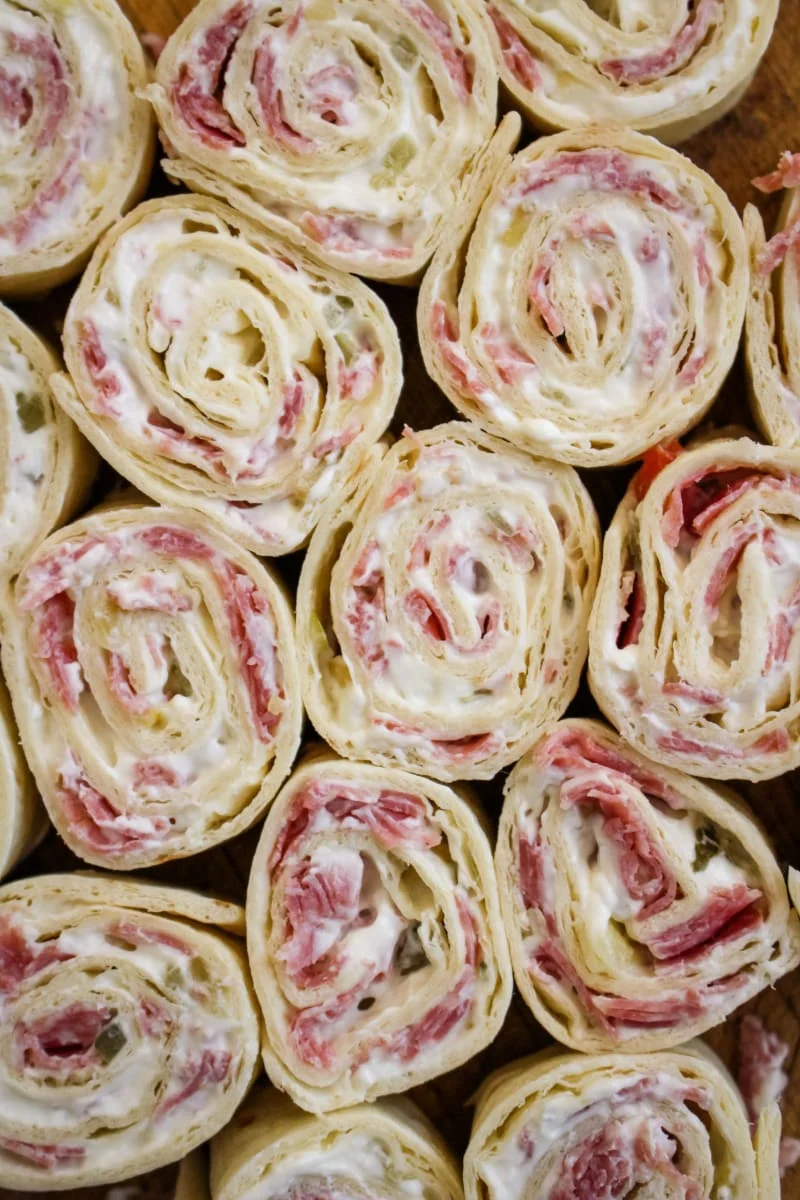 Salami Pinwheels are easy to make with just four simple ingredients! They make a fun and tasty snack, lunch, or party food. #salami #appetizer #fingerfood