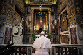 Pope Francis prays in front of a crucifix that in 1552 was carried in a procession around Rome to stop the Great Plague, at the San Marcello al Corso church in Rome on March 15. VATICAN MEDIA/AFP VIA GETTY IMAGES