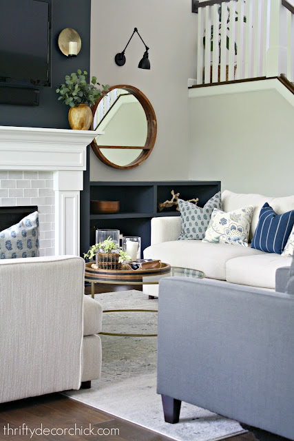 Blue green and gray pillows on light sofa