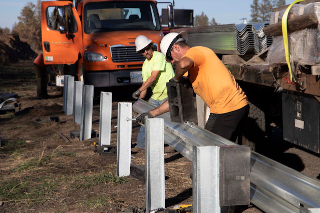 Crews installing new guardrails