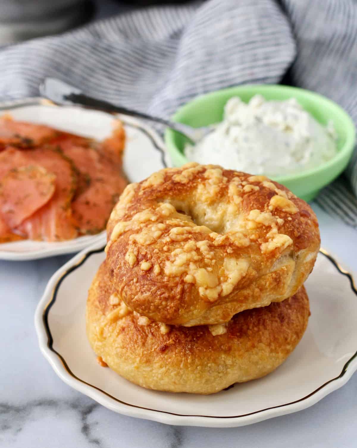 Asiago Cheese Bagels with salmon and cream cheese in the background.