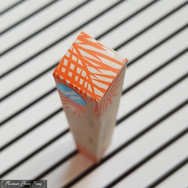 top of lipgloss box with orange palm leaf print