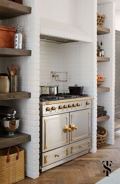 Kitchen with luxurios built in range in French Tudor Renovation by Summer Thornton