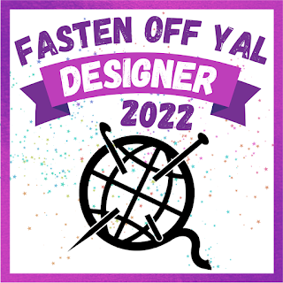 A square with a purple border and a stylized globe with a yarn tail, and a knitting needle and crochet hook poked through it. Above the globe-yarn ball are the words, in purple, "Fasten Off YAL Designer 2022"