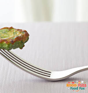  A close-up of a single Zucchini fritter with a fork. 