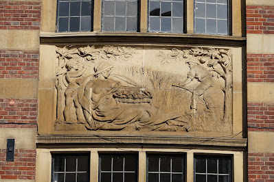 Stone relief of an agricultural scene and scantily draped goddess.