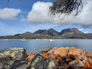 granite rock mountains overlook boats anchored in a bay