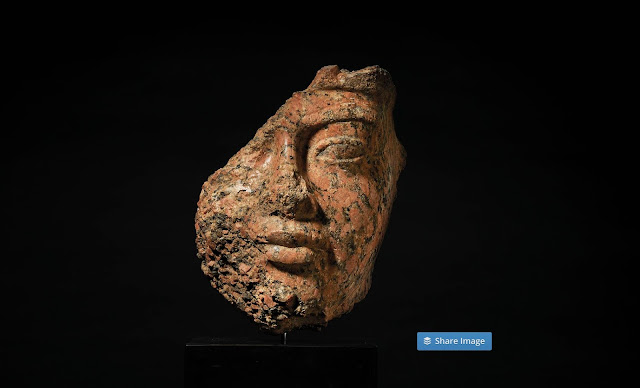 The partial fragment of King Amenhotep's statue or bust which is made of red granite