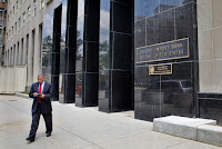 In this July 28, 2015, file photo, a man walks out of the Export-Import Bank of the United States in Washington. A strong coalition of establishment-backed Republicans and House Democrats voted overwhelmingly Oct. 27 to revive the Export-Import Bank, dealing a defeat to tea party conservatives and Speaker Paul Ryan. (Credit: AP Photo/Jacquelyn Martin) Click to Enlarge.