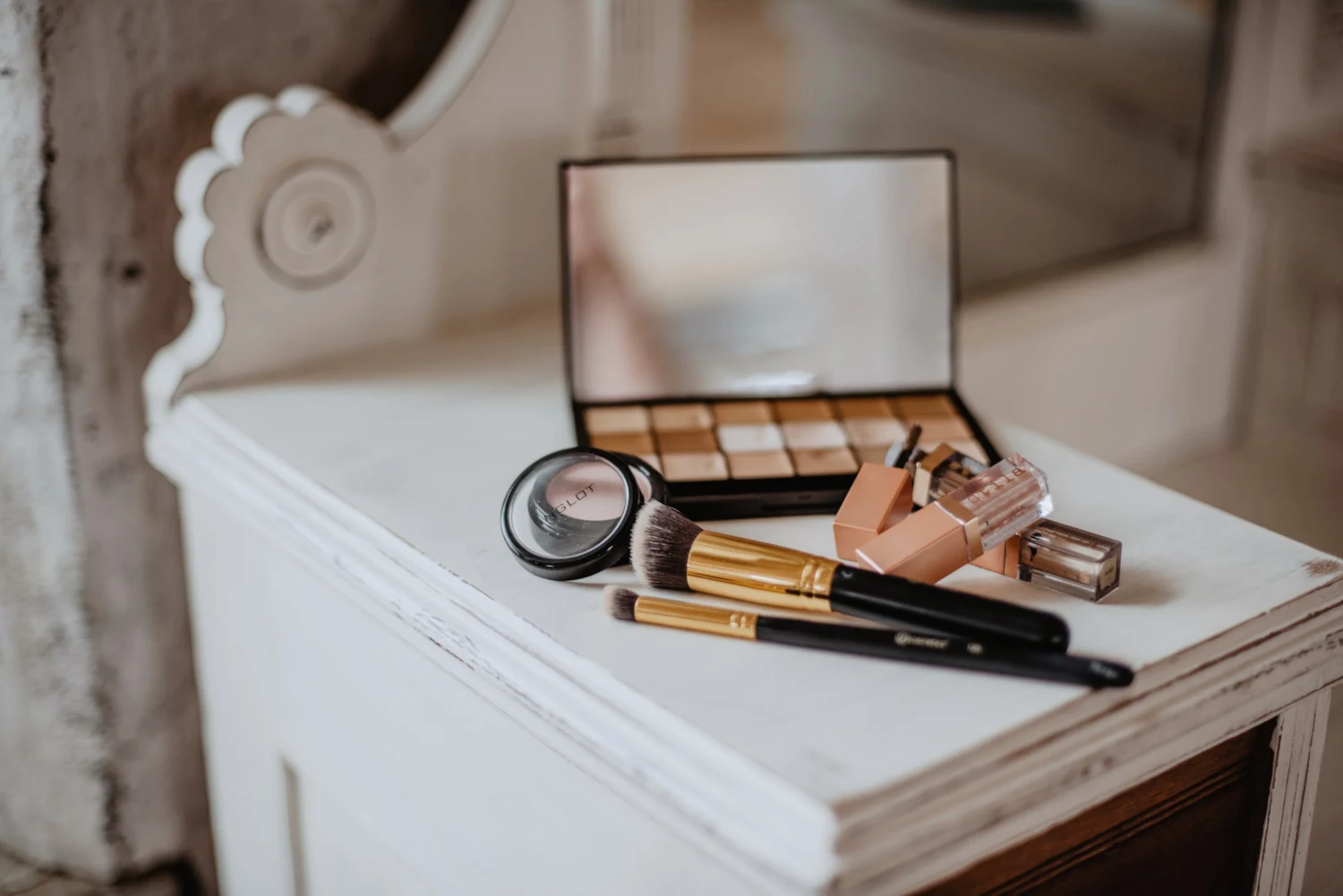 close-up of a makeup stash that is laying on a wooden vanity