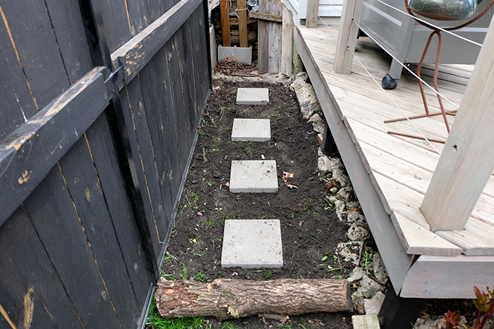 tossing down four pavers for a walkway