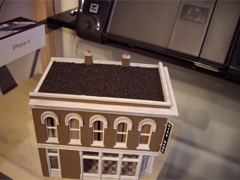 Sand covered roof of a completed DPM The Other Corner Café kit modeled as a bank
