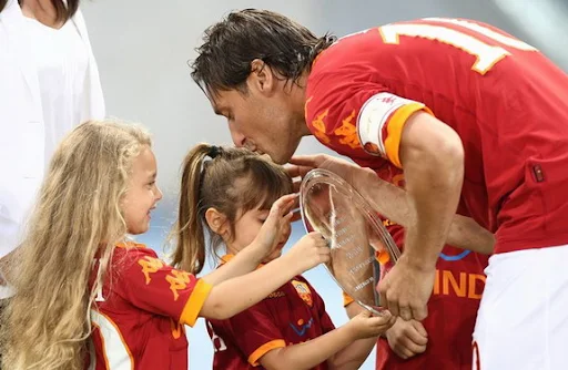 Francesco Totti and his children hold a trophy for his 206 goals for AS Roma