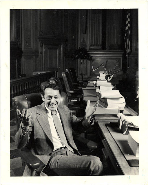 Supervisor Harvey Milk in Board of Supervisors Chambers, City Hall, 1978.  Courtesy of San Francisco History Center, San Francisco Public Library.