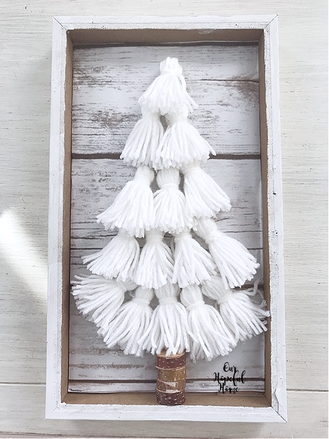 white yarn tassels CHristmas tree wood slice tree trunk