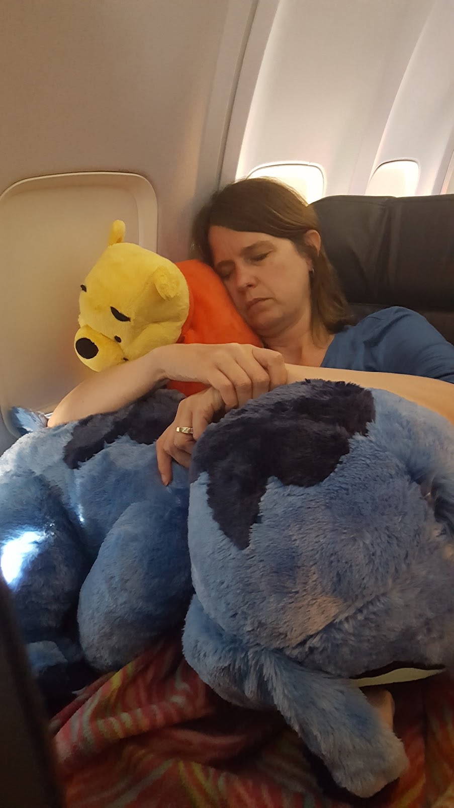 An exhausted Pam on the way back from a vacation at Disney World—Pam was normally never able to sleep on planes!