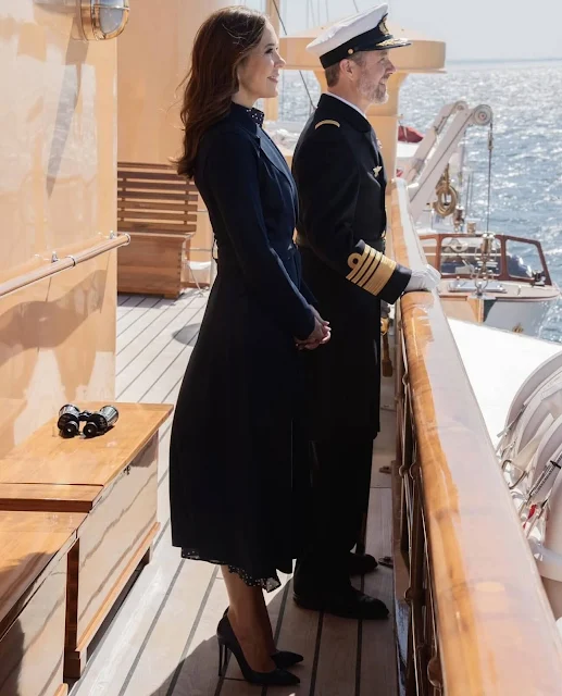 Queen Mary wore an Alison navy polka dot satin midi dress by Iris & Ink, and blue leather pumps by Gianvito Rossi