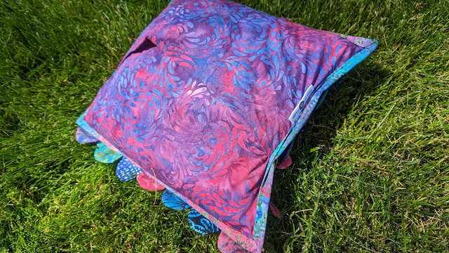 Mermaid pillow made with batik fabrics from the Hydra quilt pattern