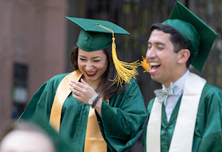 Happy male and female college graduates