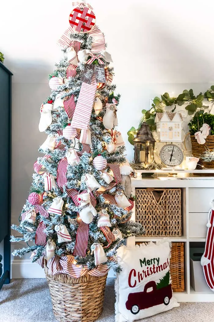 jumbo candy cane wrapped in red ticking as tree topper